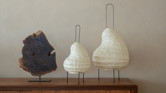 Two sizes of Japanese Washi Paper Floor Lamp “BEANS LIGHT” on a wood table in Japandi room - night lamp for bedroom