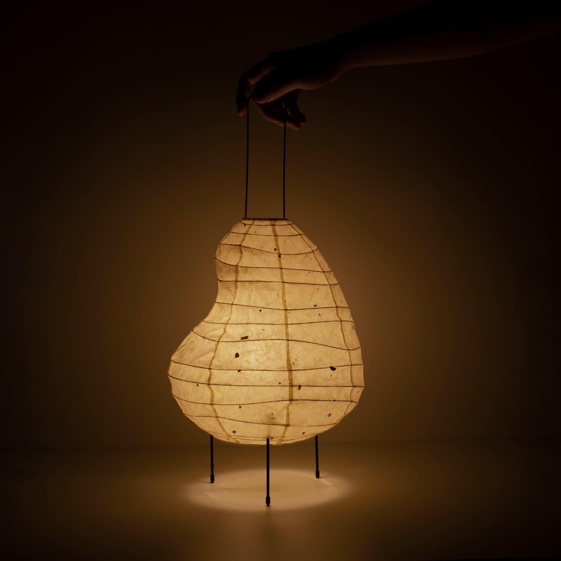Handcrafted bean-shaped paper floor lamp showcasing Gifu lantern techniques and Mino washi paper.