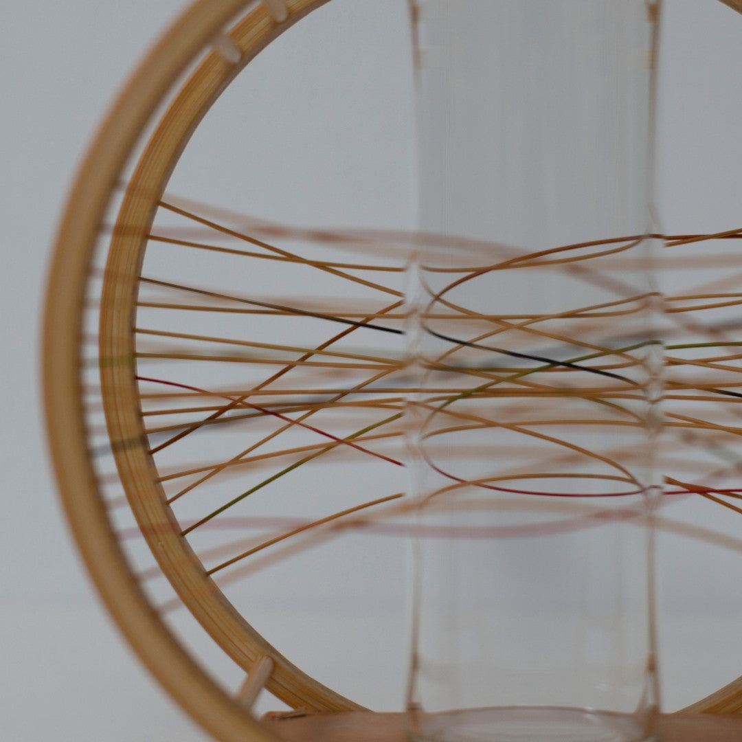 Japanese Bamboo Flower Vase 'Flowing Wind'—a circular bamboo vase with colorful weaving, capturing the essence of wind