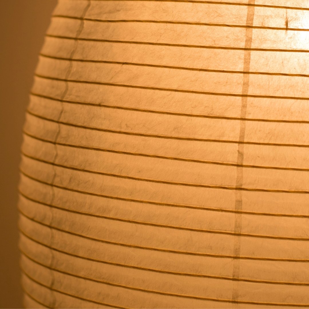 Elegant Japanese paper floor lamp "paper moon 11" emits a warm, diffused glow through high-quality washi paper
