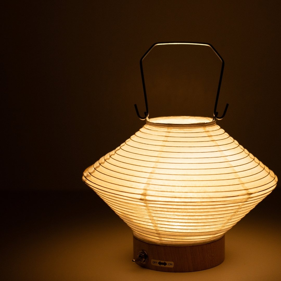 Close-up of diamond-shaped Japanese paper table lamp RIN 05, warm glowing Japanese table lamp for living room & bedroom