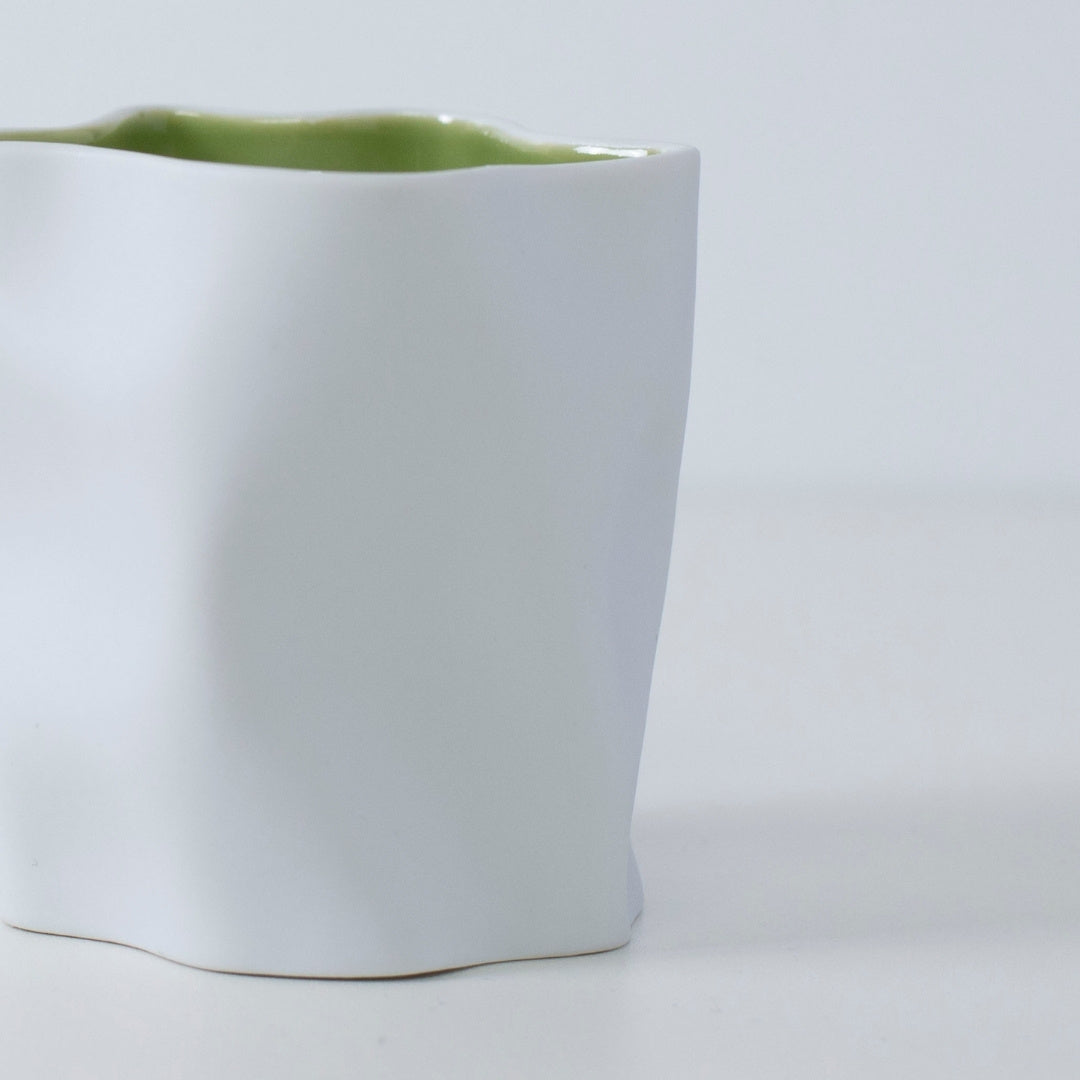 MATCHA Japanese candle in white Seto porcelain with green interior, evoking tea ceremony and incense