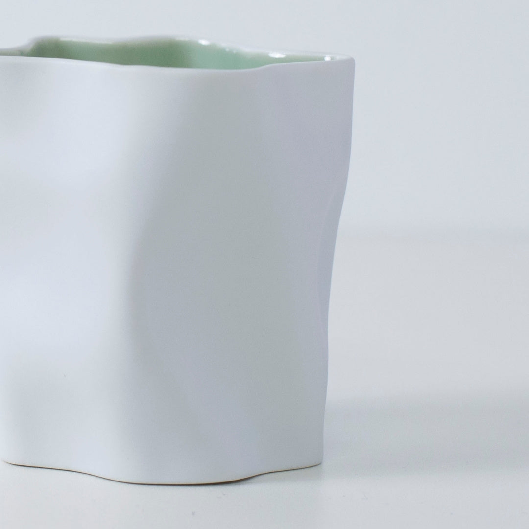 YUKI Japanese scented candle in white porcelain with frosty green interior, mint, woods, and incense