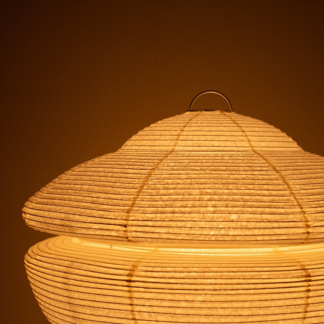Close-up of glowing Japanese paper floor lamp GEMINI 01, warm Harusame washi Japanese lamp