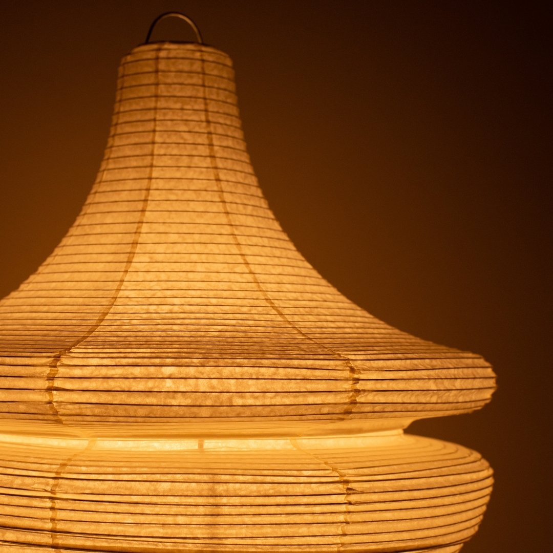 Close-up of glowing Japanese paper floor lamp GEMINI 02, warm sculptural washi Japanese lamp