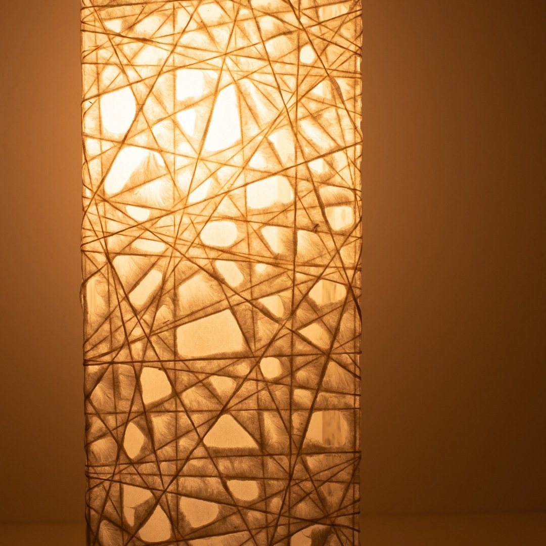 Close-up glowing white Japanese floor lamp ME-LOOK 01, intricate Melook washi paper
