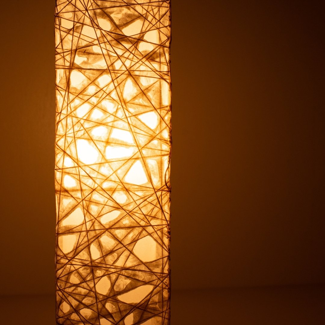 Close-up glowing white Japanese floor lamp ME-LOOK 02, intricate Melook washi paper shade