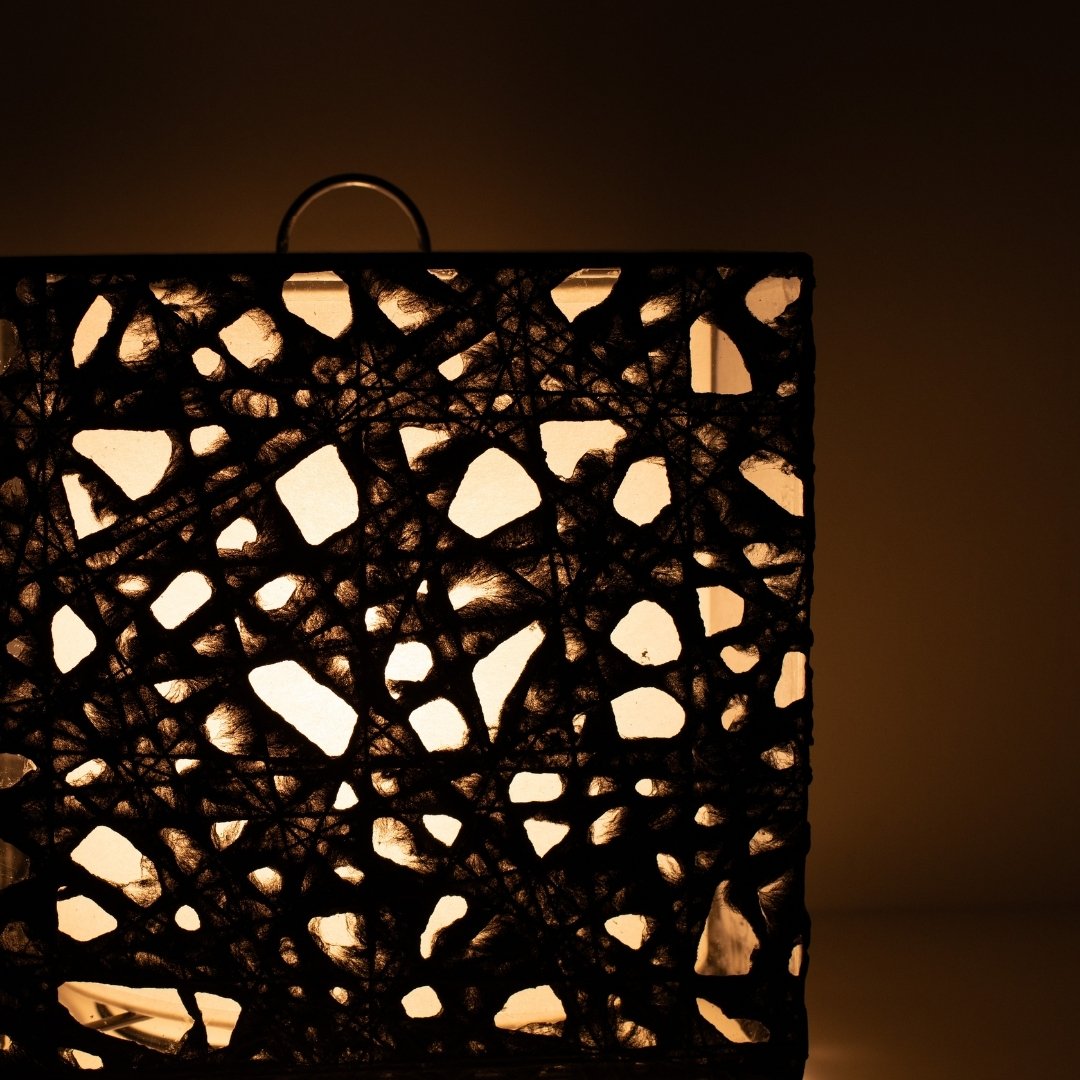 Close-up glowing black Japanese floor lamp ME-LOOK 03, intricate Melook washi paper shade