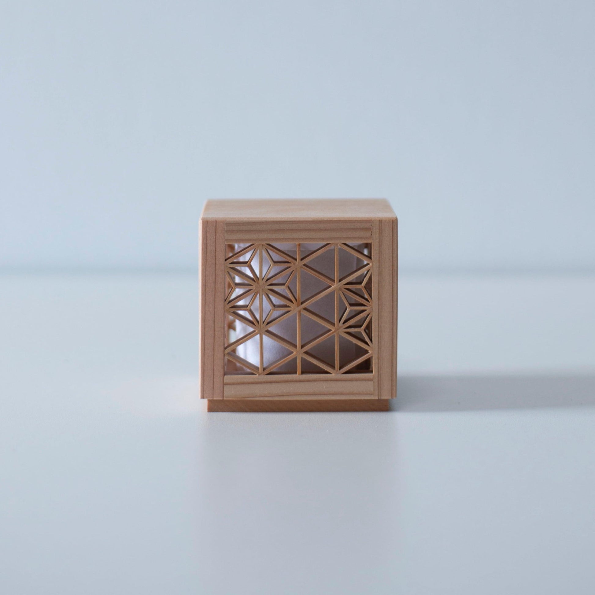 Japanese woodworking mini lamp on a white table.
