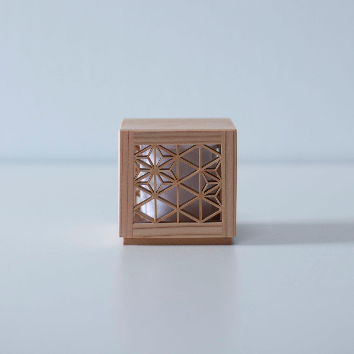 Japanese woodworking mini lamp on a white table.