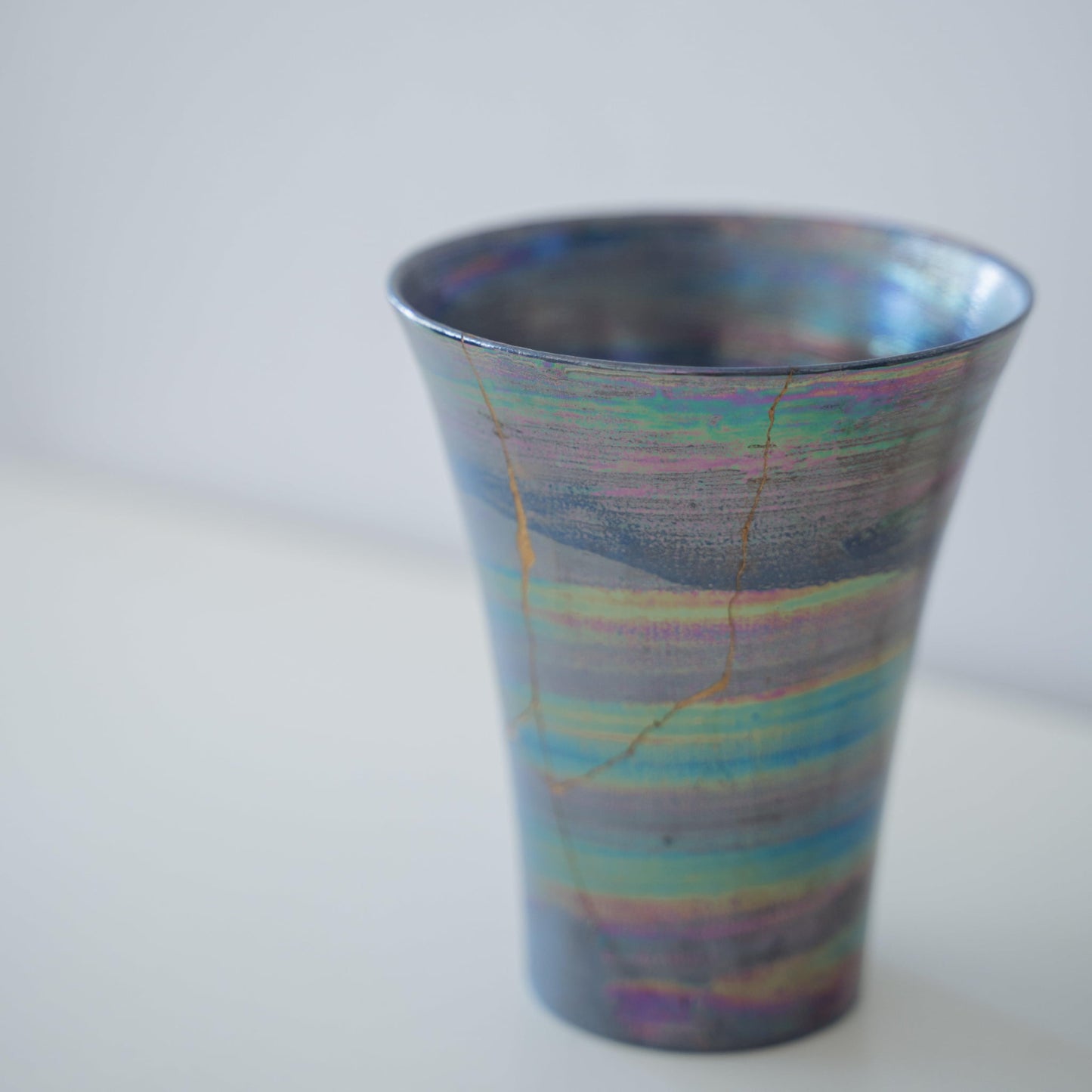 Close-up of Kintsugi Cup "Sirius" side, highlighting the intricate Kintsugi repairs