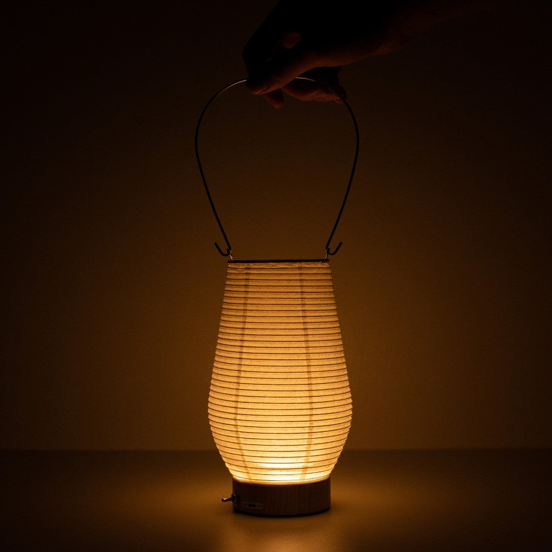 Hand touching Japanese paper table lamp RIN 02, portable Mino washi Japanese table lamp for living room & bedroom