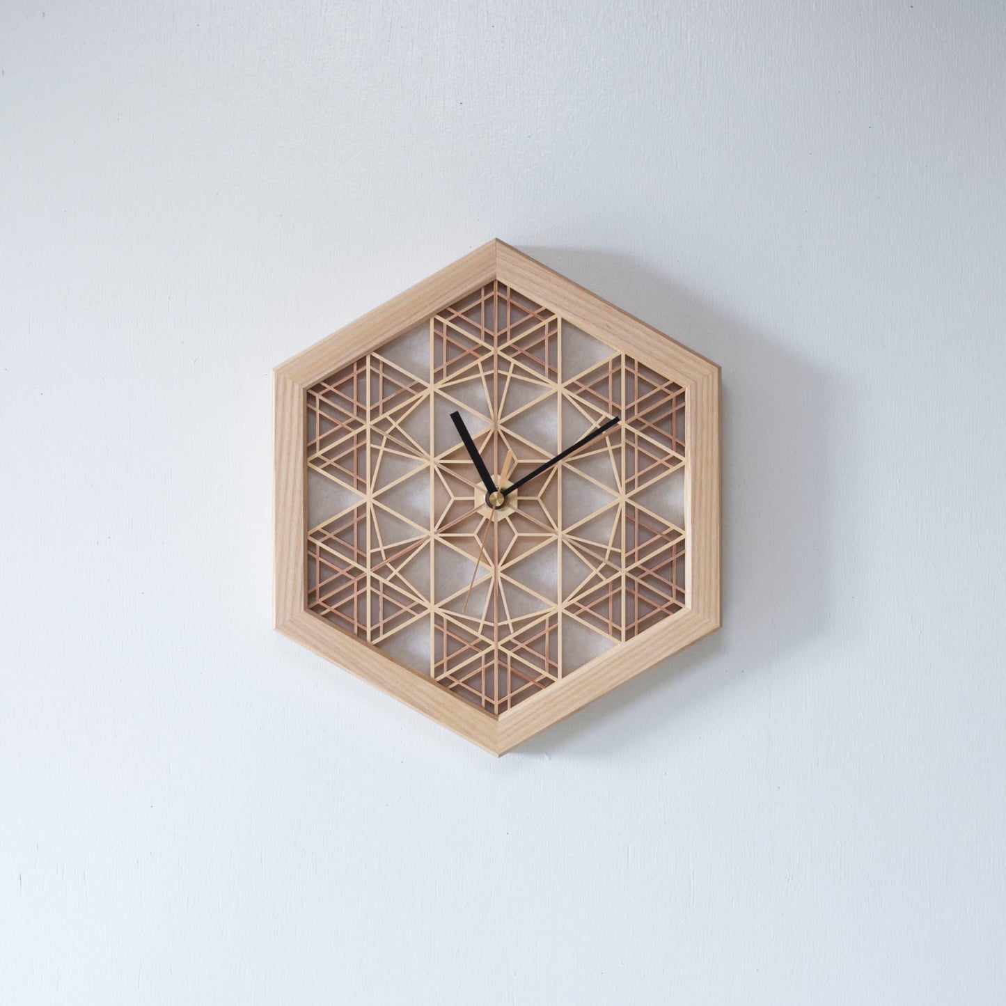A traditional Japanese kumiko clock crafted from intricately joined wooden pieces. Over 1400 years of craftsmanship are embodied in this timepiece.