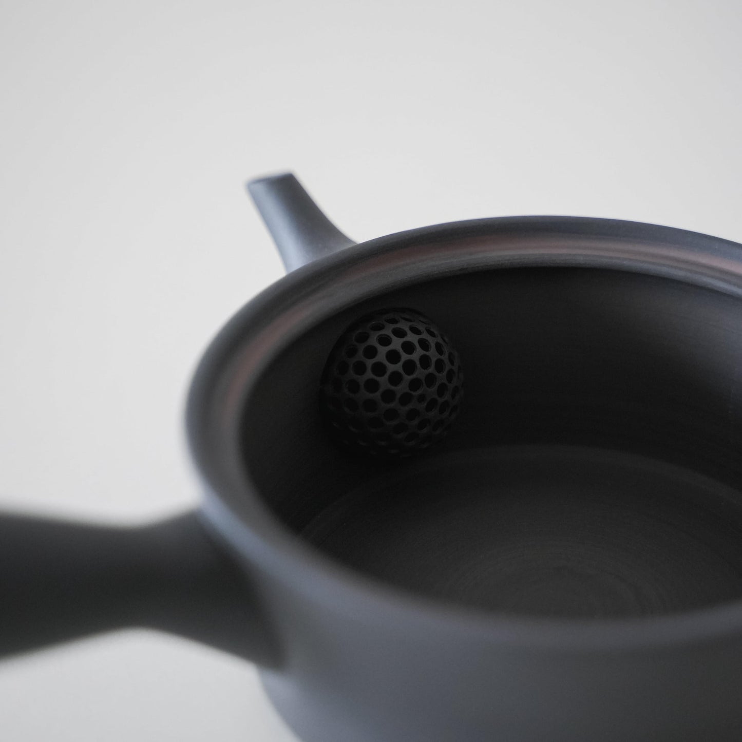 Inside a Black Japanese Banko Ware Teapot with Strainer - Close-up View