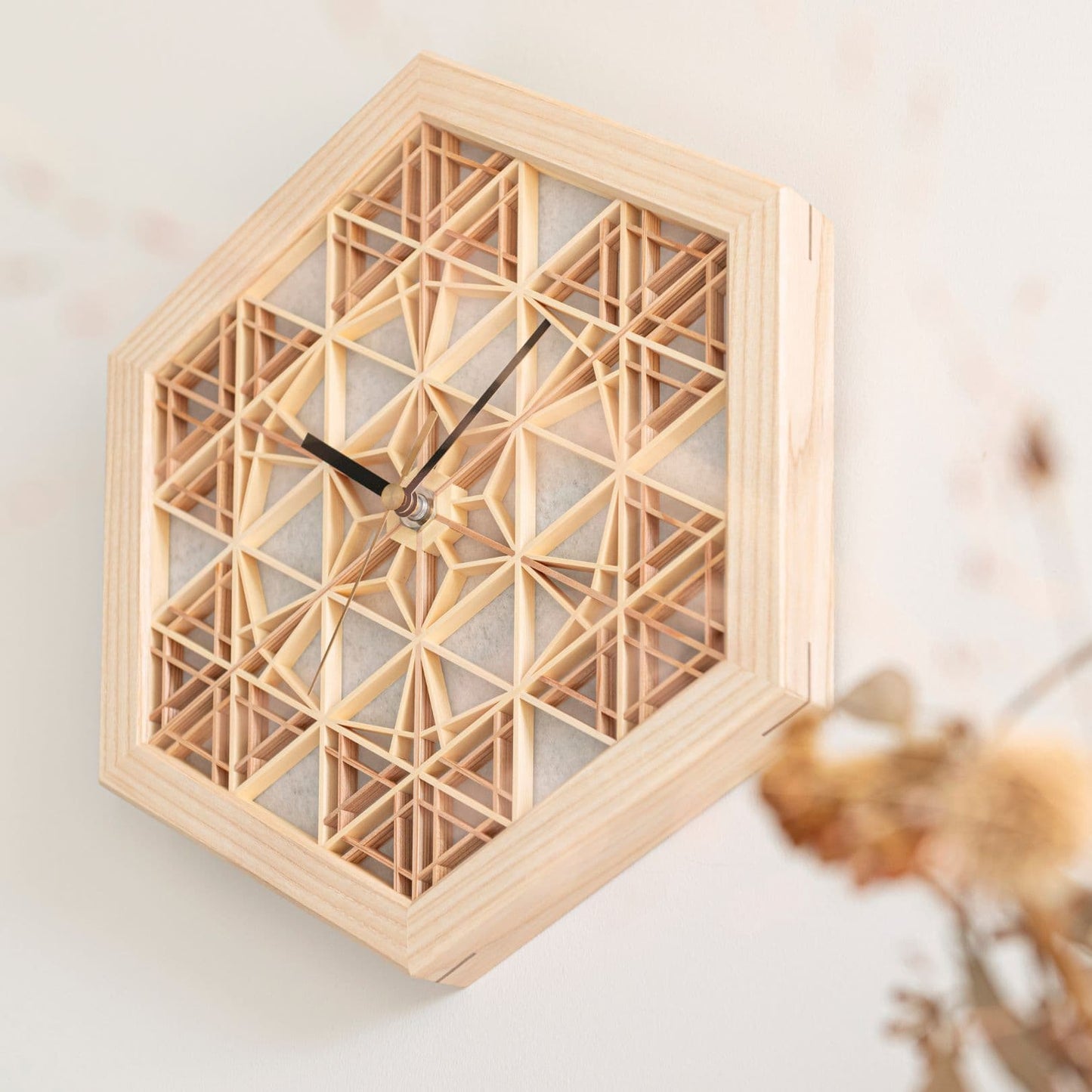 Japanese kumiko clock on a wall in a Japandi living room.