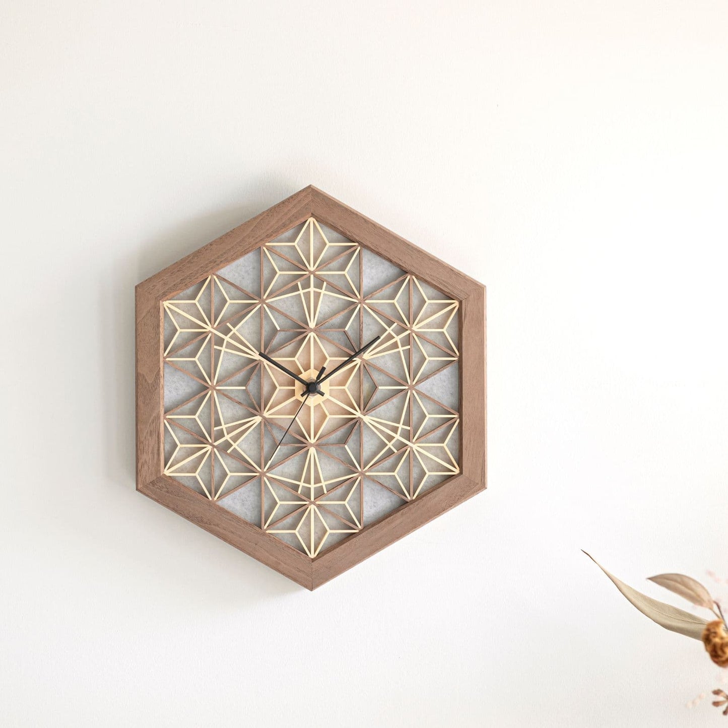 Japanese kumiko clock on a wall in a Japandi living room.