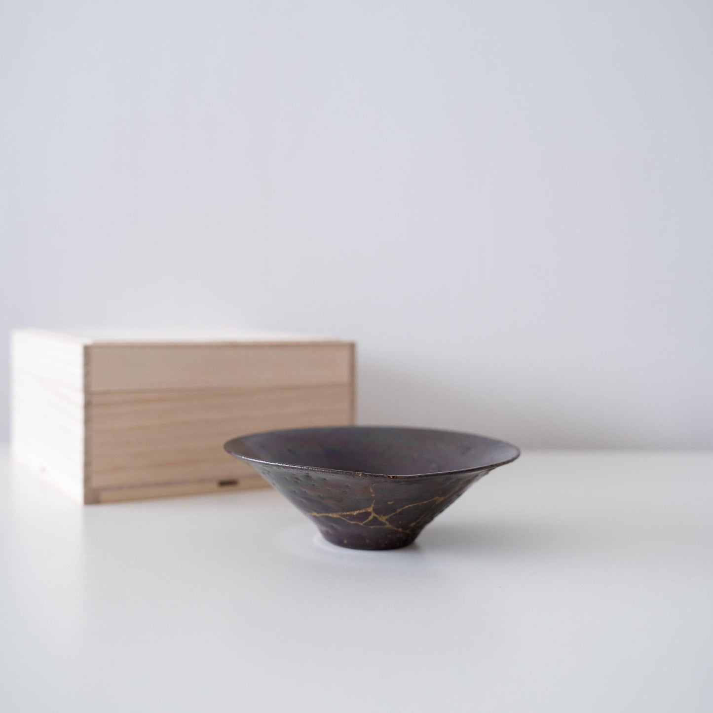 Gift set of a leaf-shaped bowl repaired with Kintsugi, a traditional Japanese technique, and a paulownia wood box.