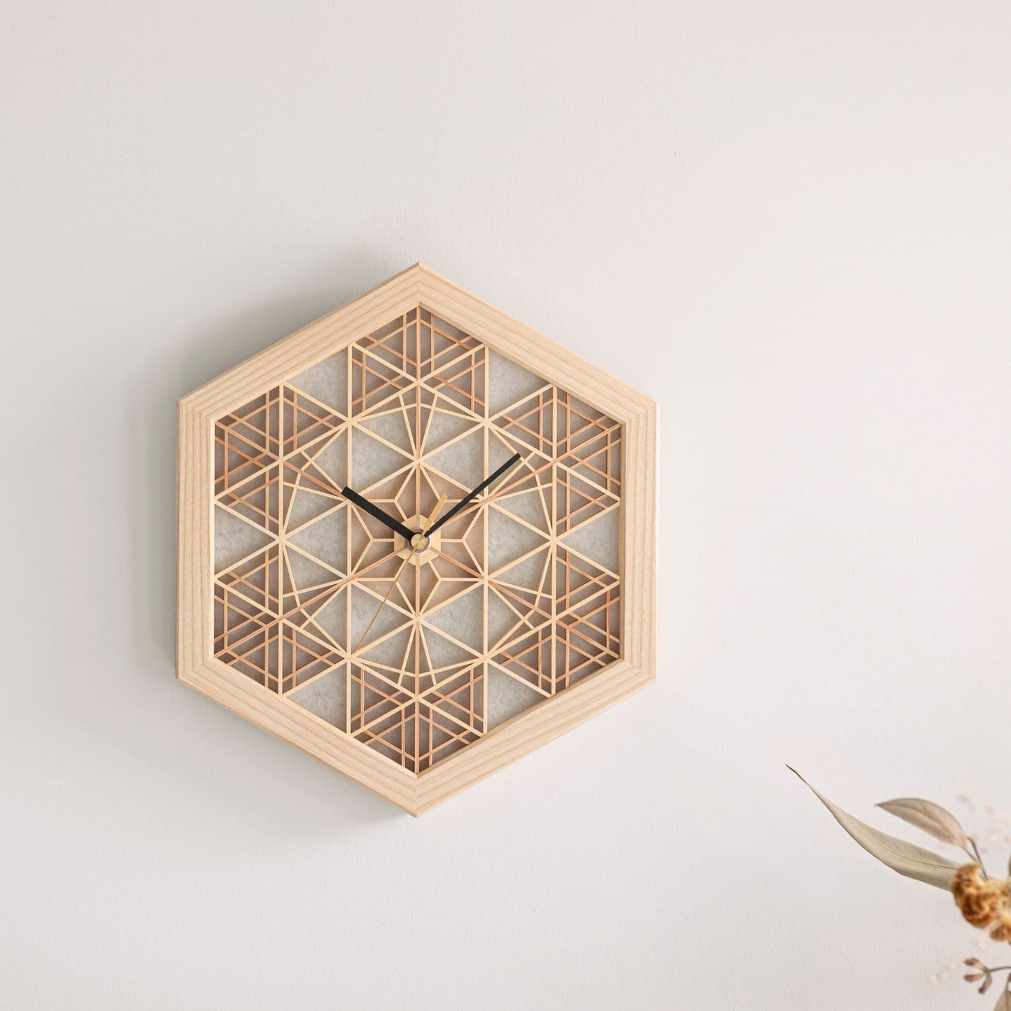 Japanese kumiko clock on a wall in a Japandi living room.