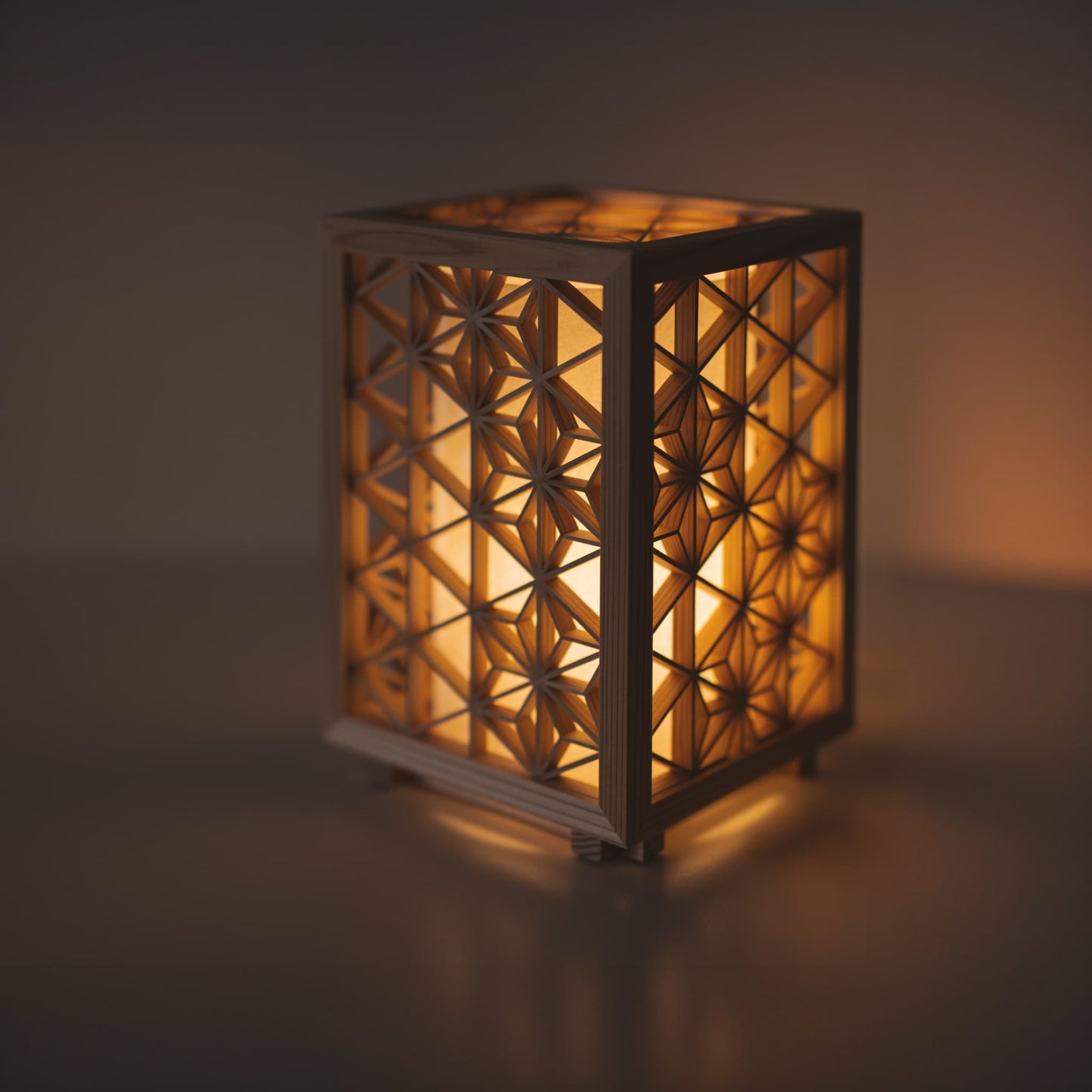 Japanese kumiko table lamp meticulously handcrafted using the 1400-year-old "kumiko" technique, assembling 360 pieces of premium Akita cedar into a mesmerizing cubic form.