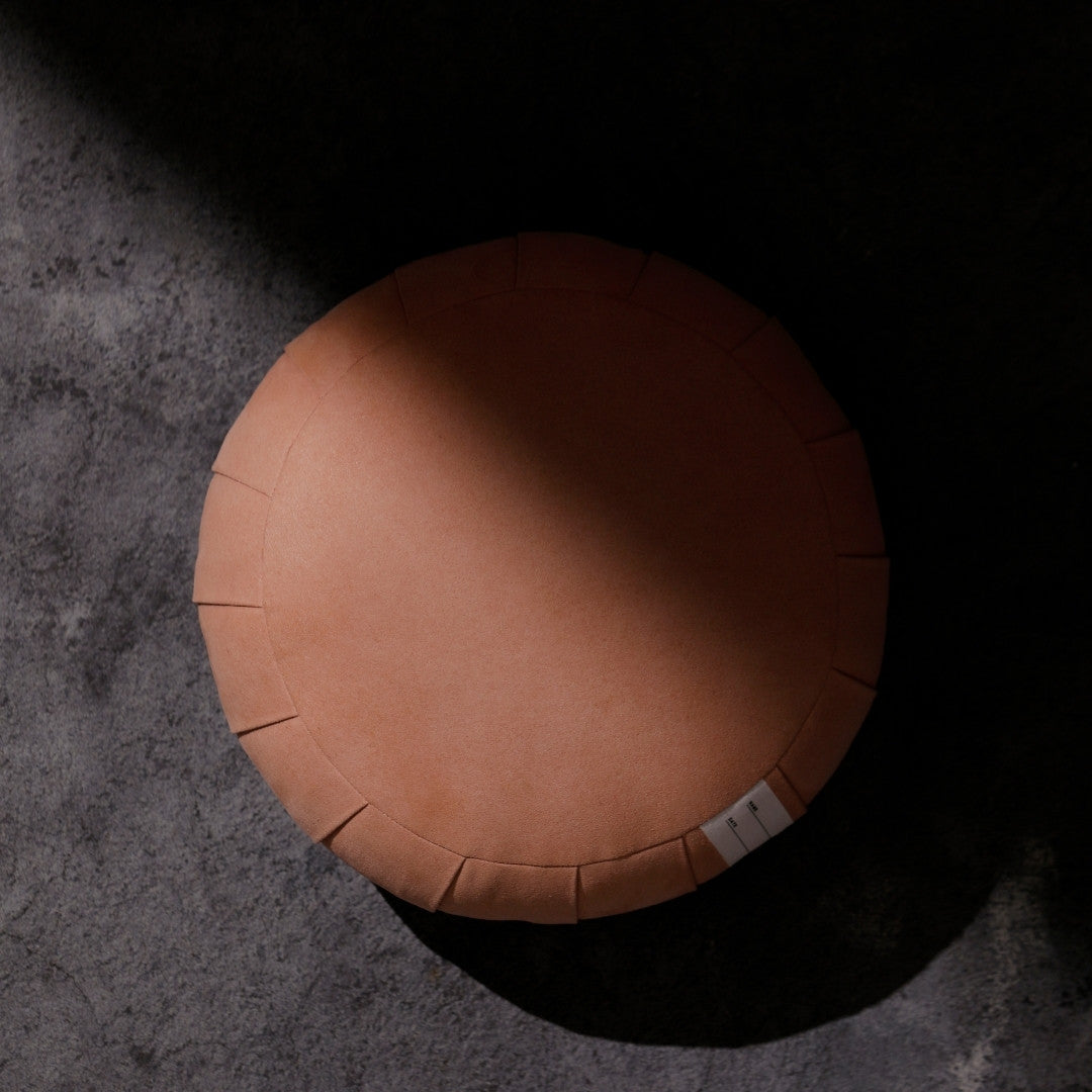 Smoky Rose ZAF MASTER meditation cushion zafu pillow in a dark room