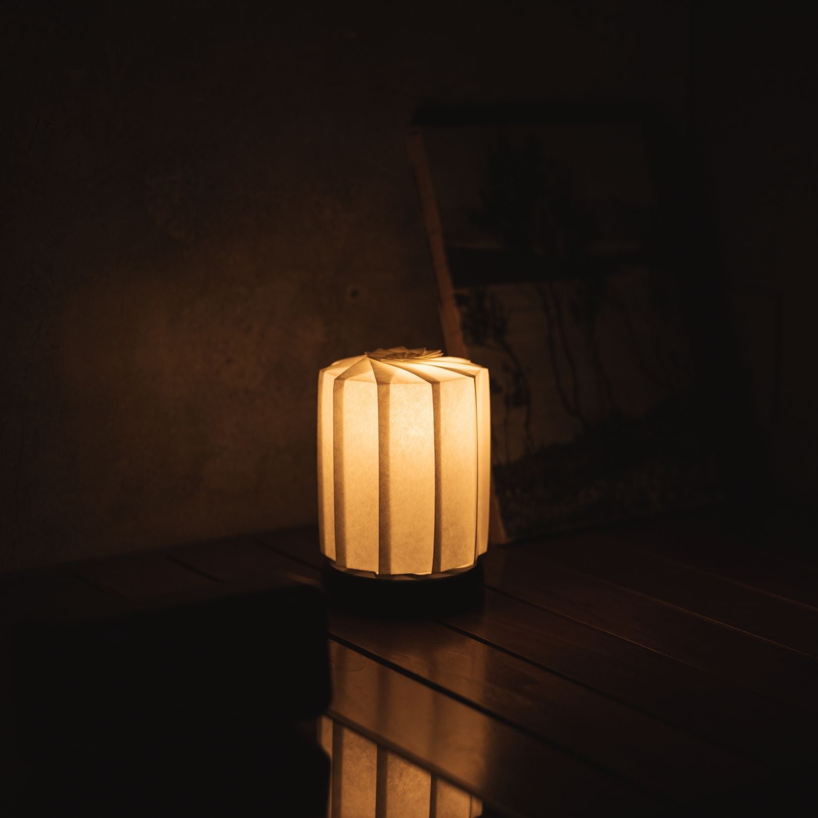 Japanese Paper Origami Table Lamp "Flower of Light tutu M" Placed on a Living Room Console Table