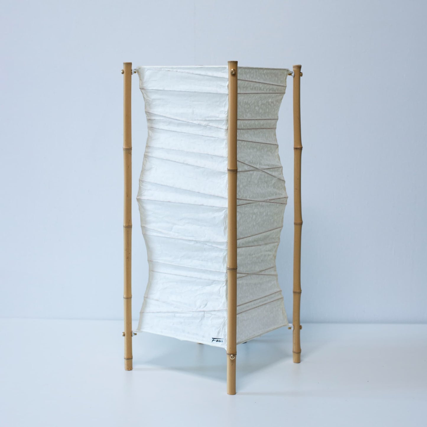 A Japanese paper floor lamp on white background.