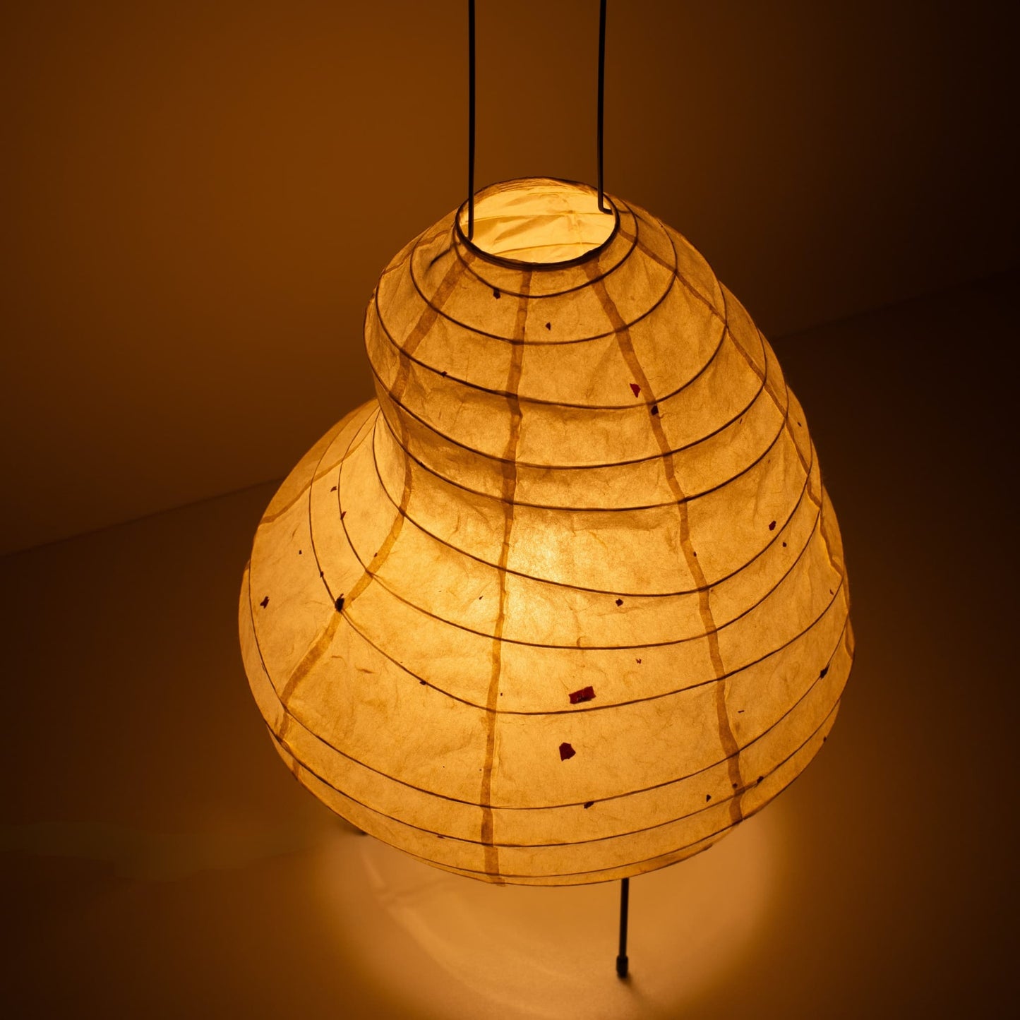 Close-up of a unique bean-shaped paper floor lamp made with Gifu lantern techniques and Mino washi paper.