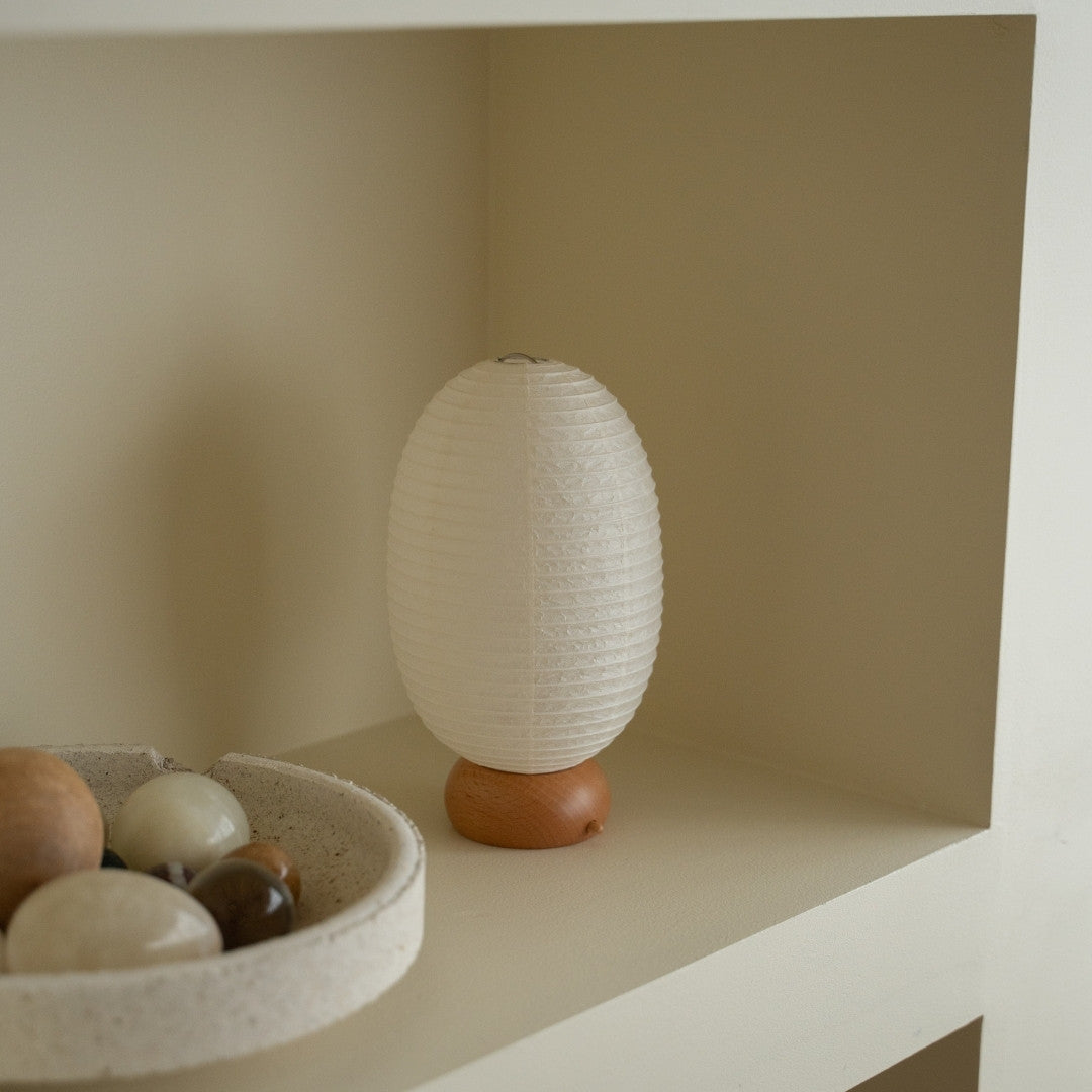Japanese Paper Table Lamp "Dinosaur" on a white shelf in Japandi style room – white washi paper lantern for Japandi living room