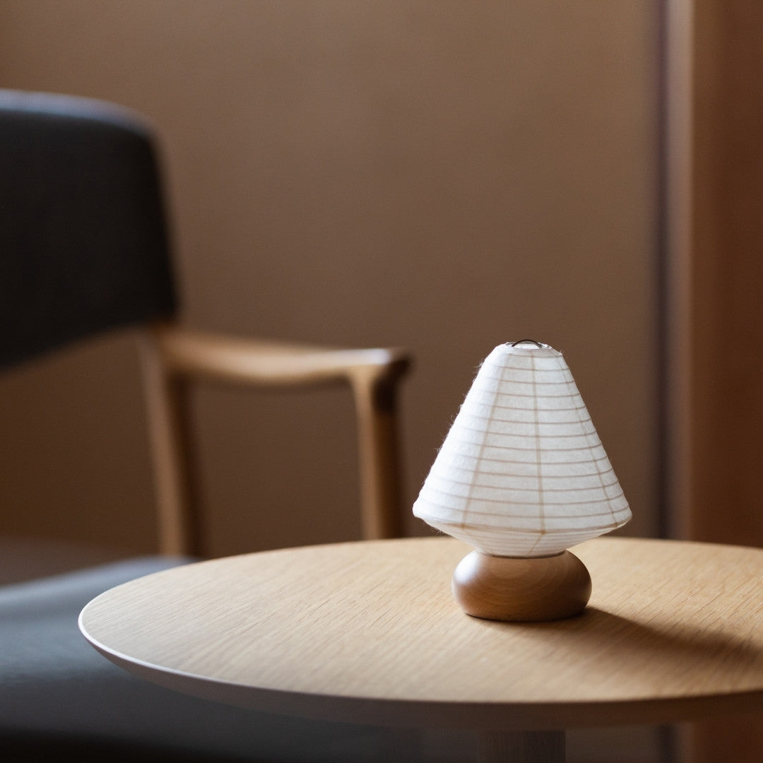 Japanese Paper Table Lamp "Mini Triangle" on a wooden table in a living room