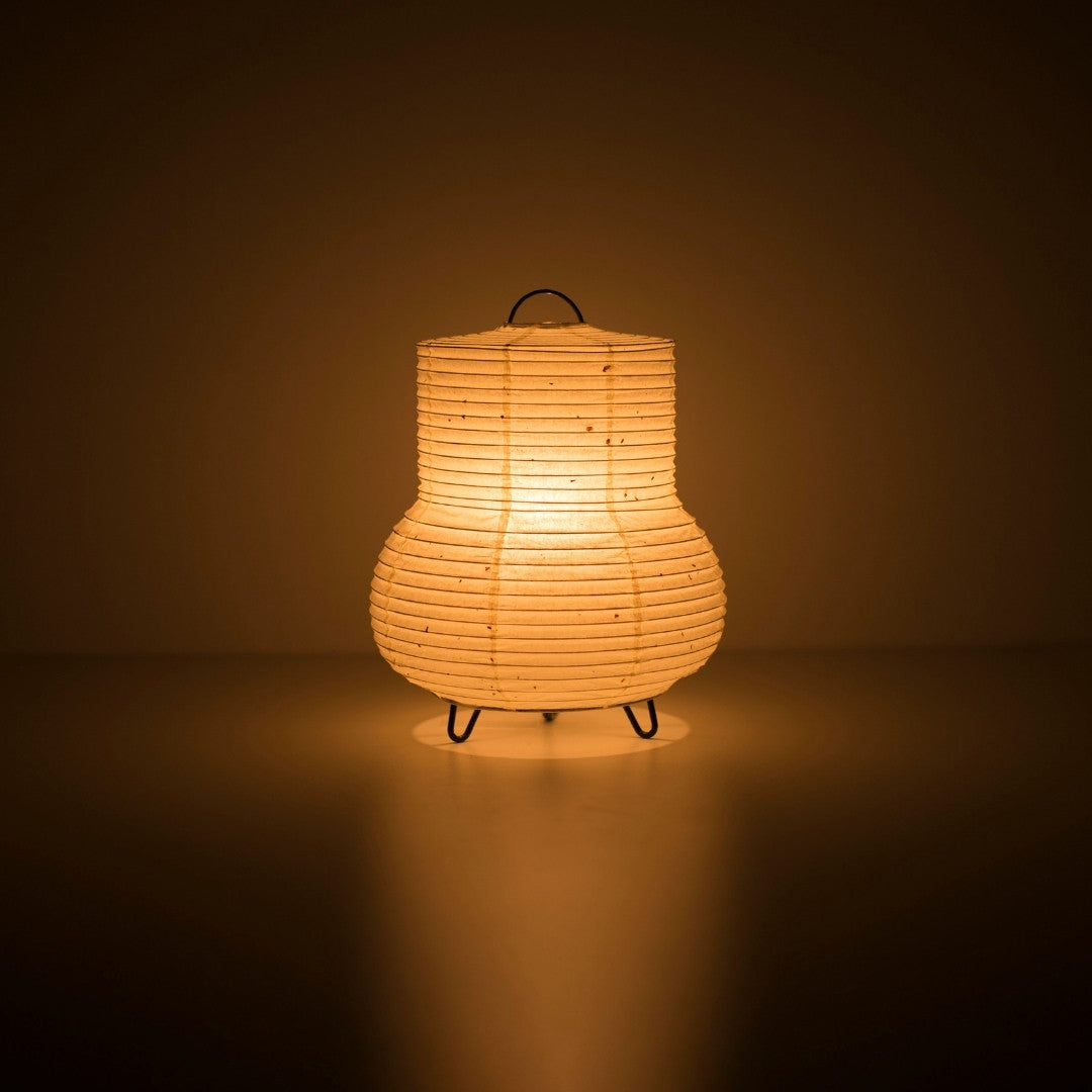 Japanese Paper Table Lamp "PAPERSON 02" illuminating a dark room - Unique Washi Paper bedside lamp