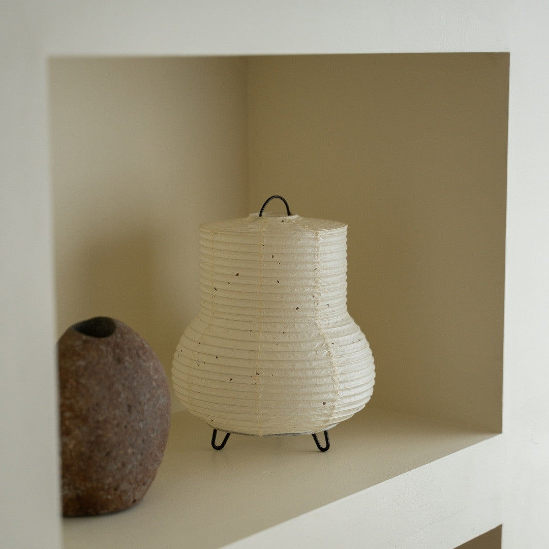 Japanese Paper Table Lamp "PAPERSON 02" on a white shelf in Japandi style living room – Unique paper table lamp for Japandi interior