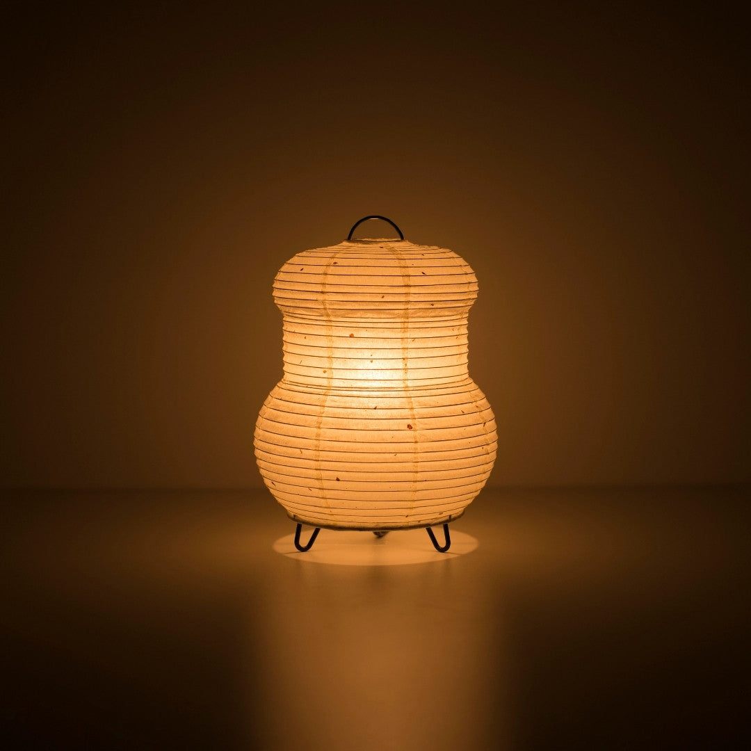 Japanese Paper Table Lamp "PAPERSON 03" emitting warm glow in a dark room – Authentic Japanese paper table lamp