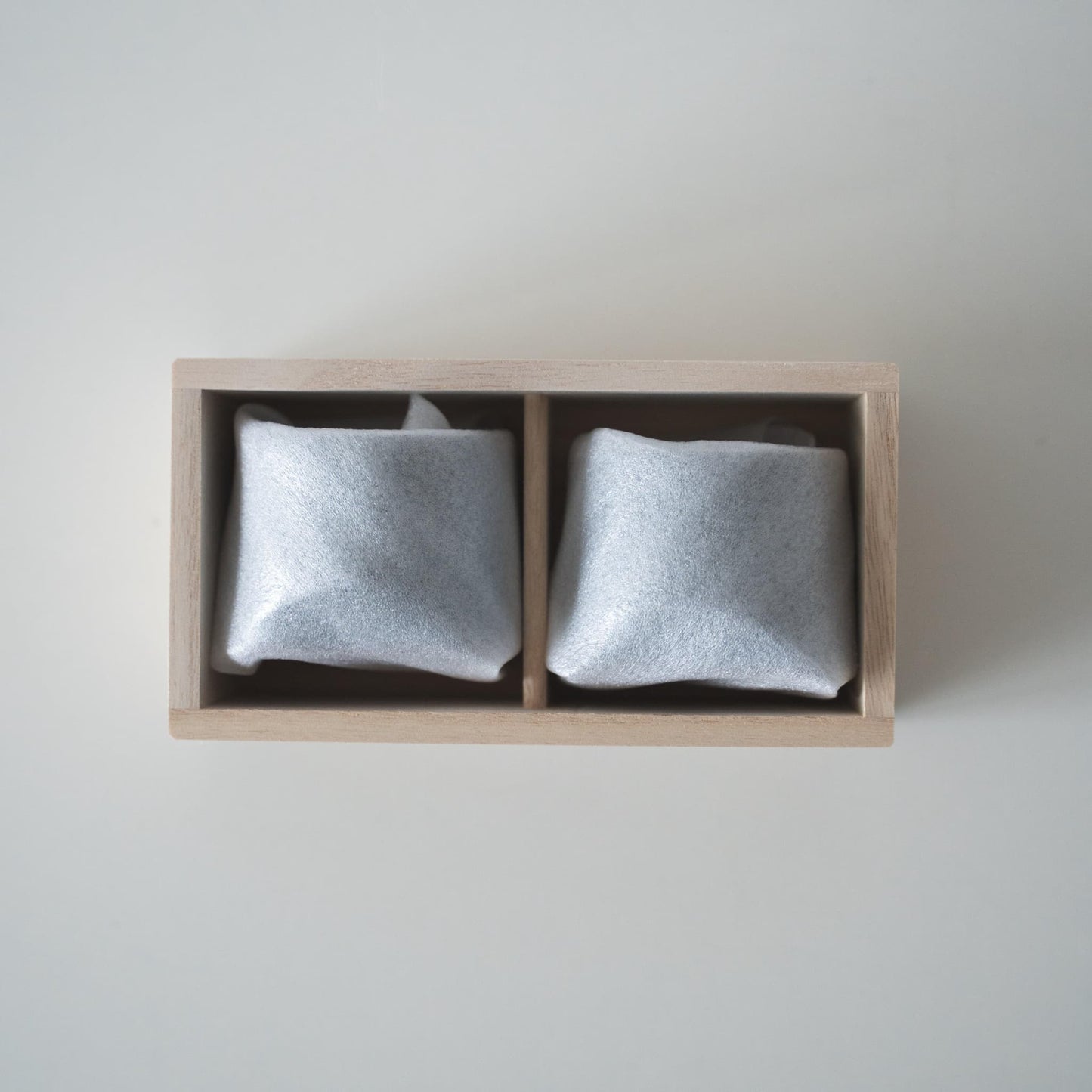 Gift set of two iron-colored sake cups, crafted using traditional Japanese roof tile techniques, presented in a paulownia wood box.