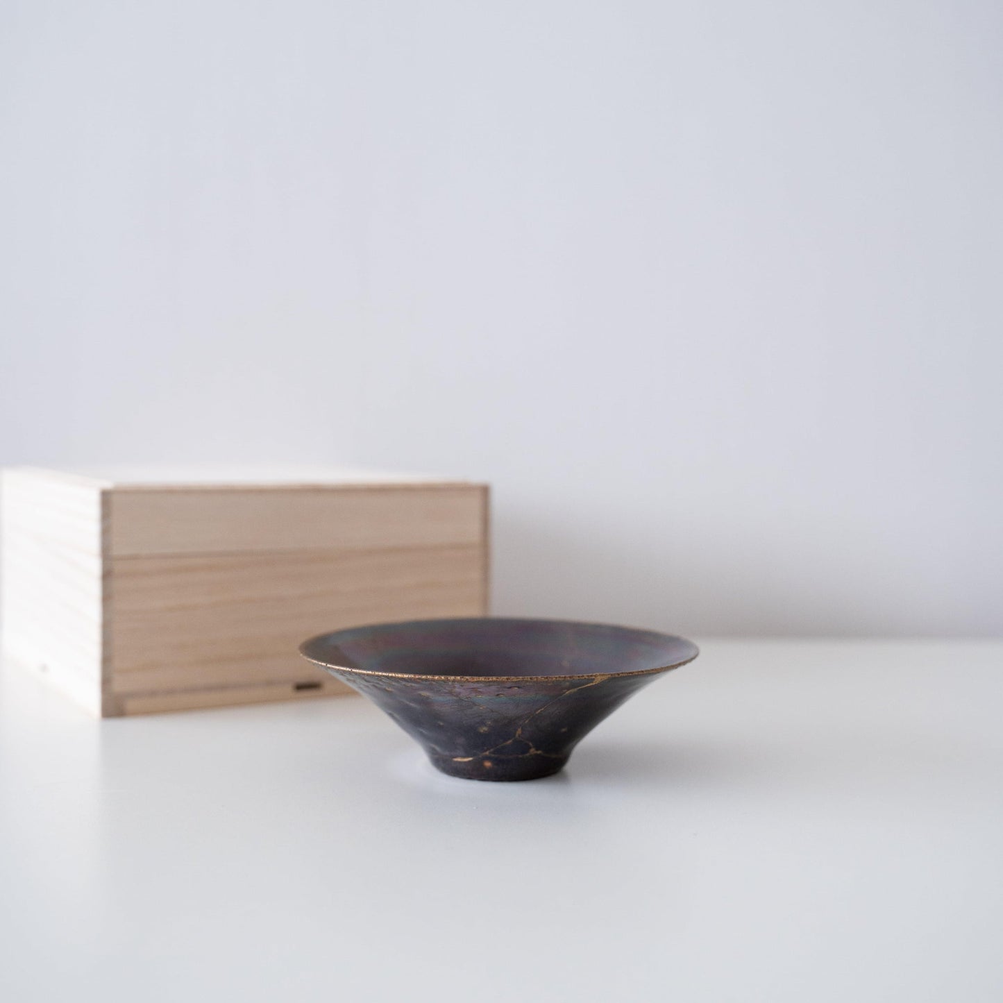 Gift set of a leaf-shaped bowl repaired with Kintsugi, a traditional Japanese technique, and a paulownia wood box.