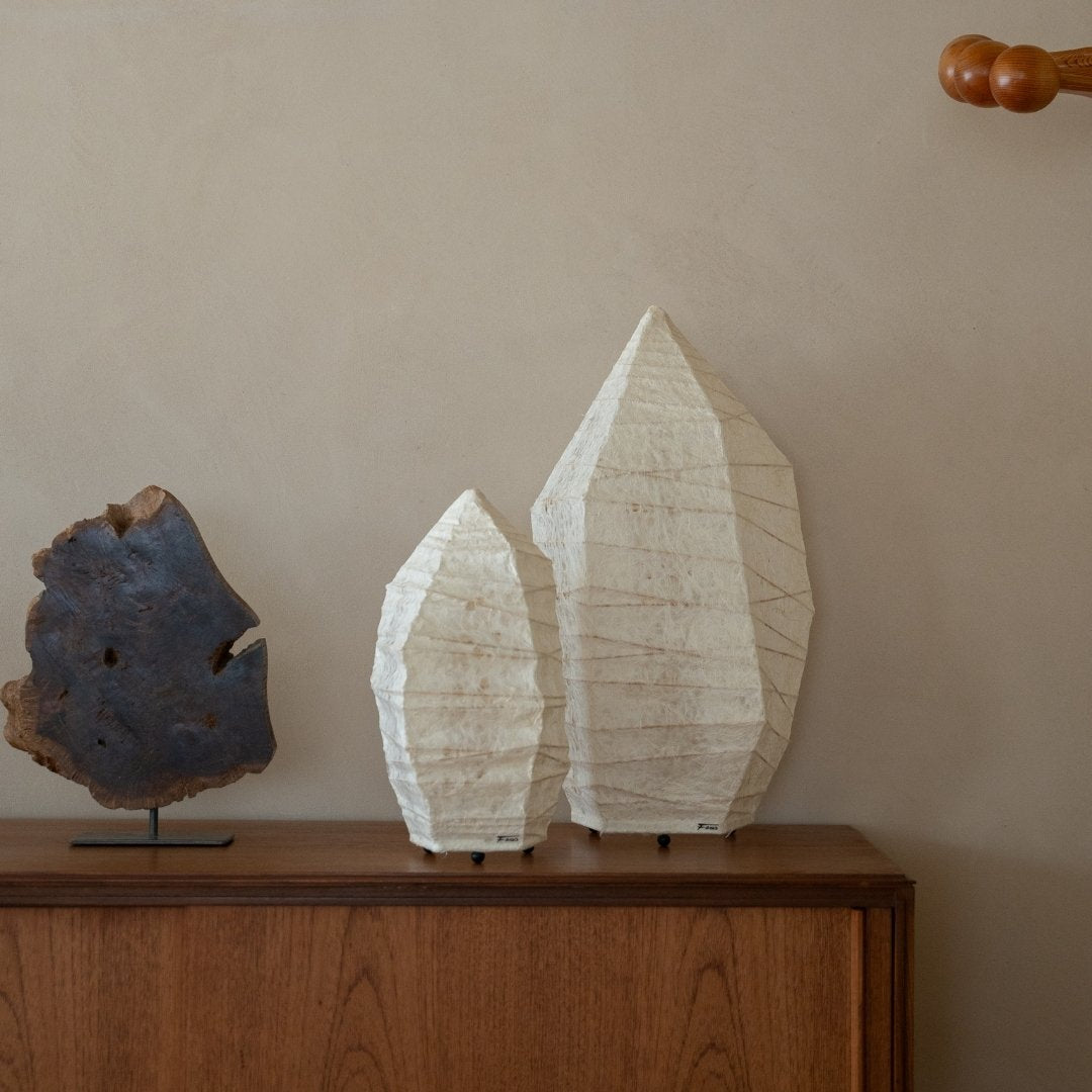 Two sizes of Japanese Washi Paper Floor Lamp “Paper Stone” on a wood table in Japandi living room - paper lamp for bedroom