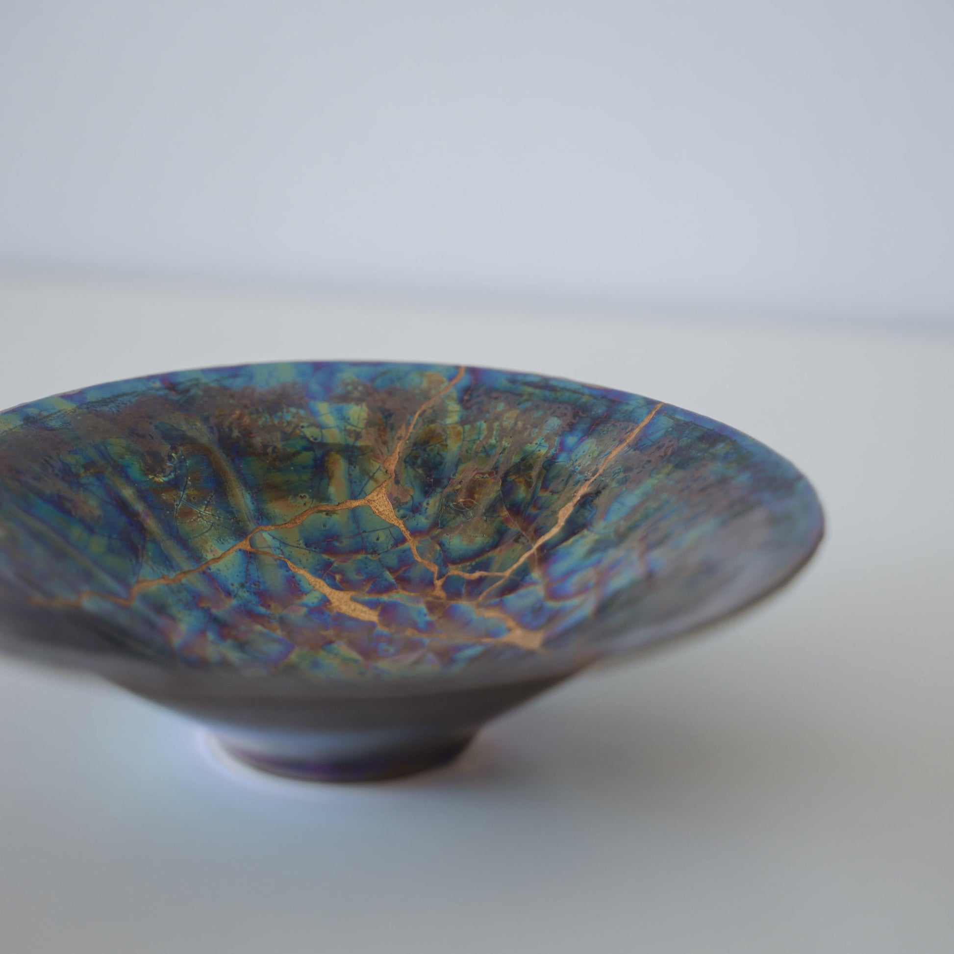 Close-up of Kintsugi Bowl "Blue Moon" side, highlighting the intricate Kintsugi repairs