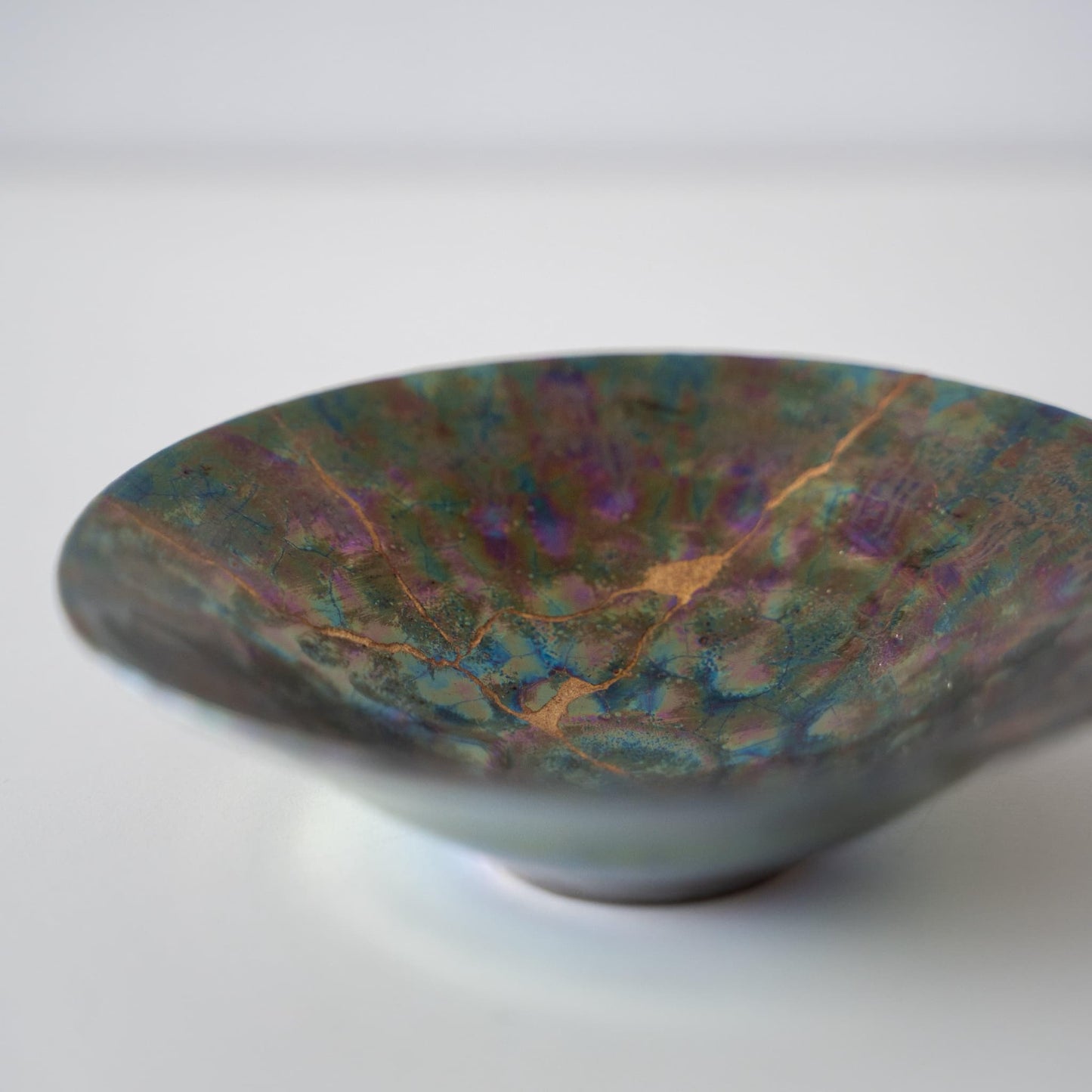 Close-up of Kintsugi Bowl "Green Nebula"
side, highlighting the intricate Kintsugi repairs