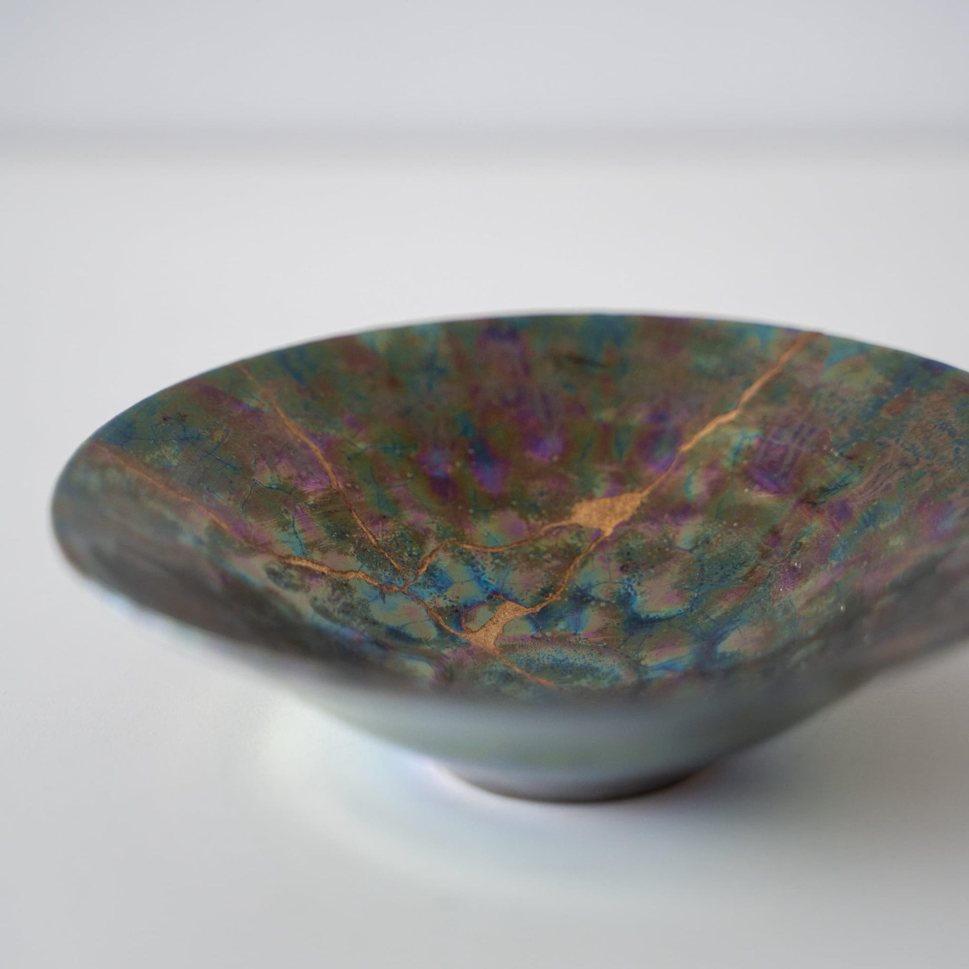 Close-up of Kintsugi Bowl "Green Nebula" 
 side, highlighting the intricate Kintsugi repairs