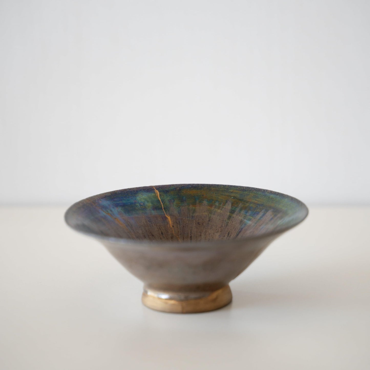 Side view of Kintsugi Bowl "Iris Rose" in a white background