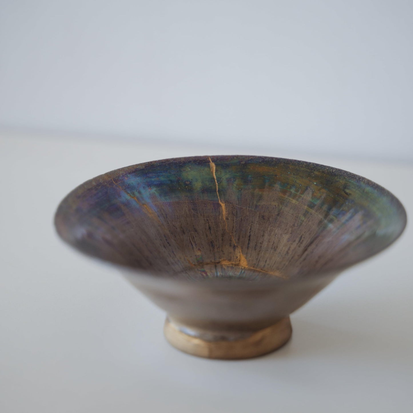 Side close up view of Kintsugi Bowl "Supernova" in a white background