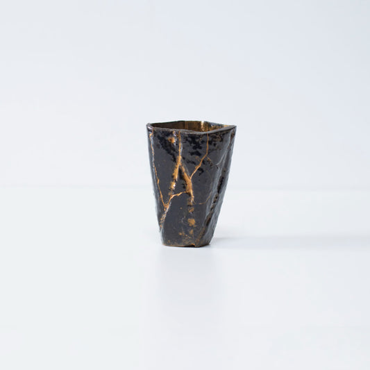 Side view of Pentagon Kintsugi Cup "Tenmoku" Black 01 against white background