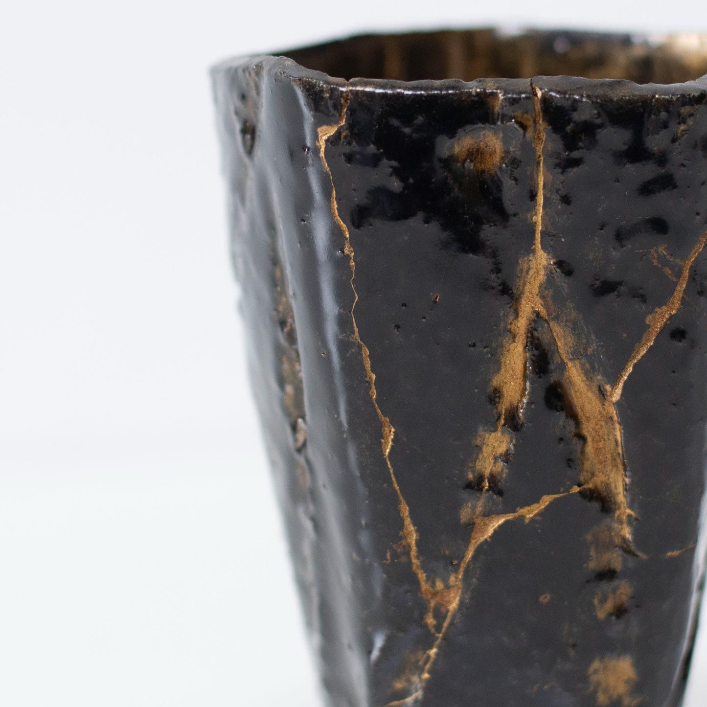 Close-up of Kintsugi repair on Pentagon Kintsugi Cup "Tenmoku" Black 01