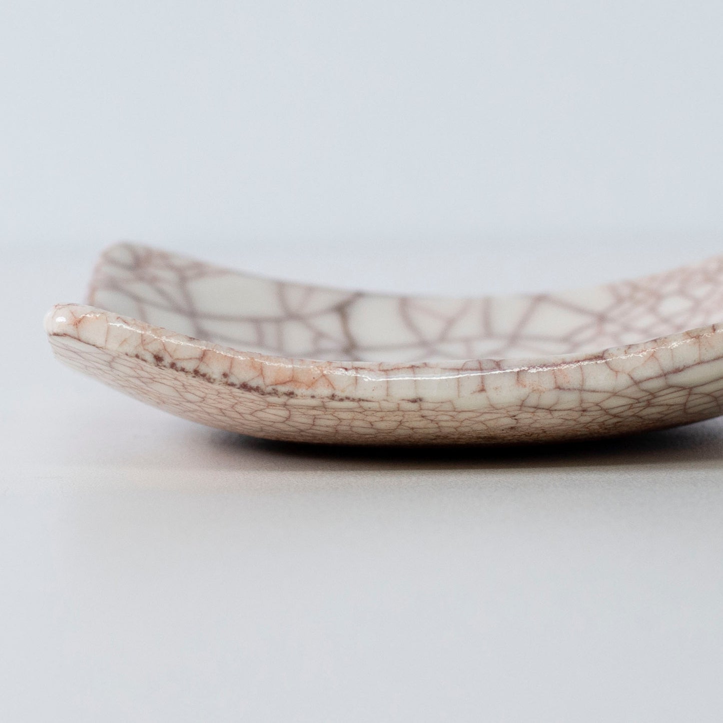 Close-up of the side profile of Kintsugi Square Plate "Vermilion Crackle" 05, highlighting the texture.