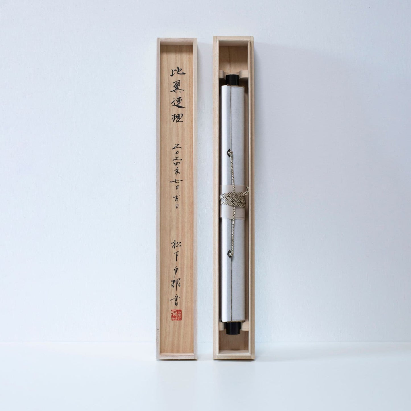 Traditional Japanese scroll stored in a long wooden box with matching lid