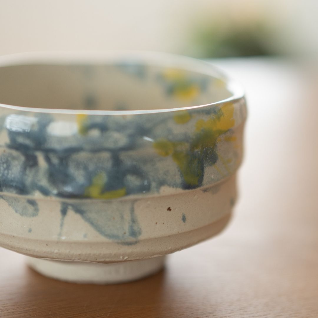 Profil de côté du bol à matcha "Splash" en grès Shino, montrant sa forme classique généreuse et la texture tactile de l'argile fabriquée à la main dans la manufacture historique Shinzan à Gifu.