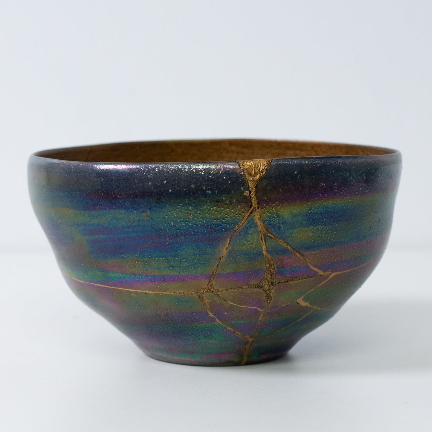 Side view of Kintsugi art bowl showing urushi lacquer and pure gold repair lines