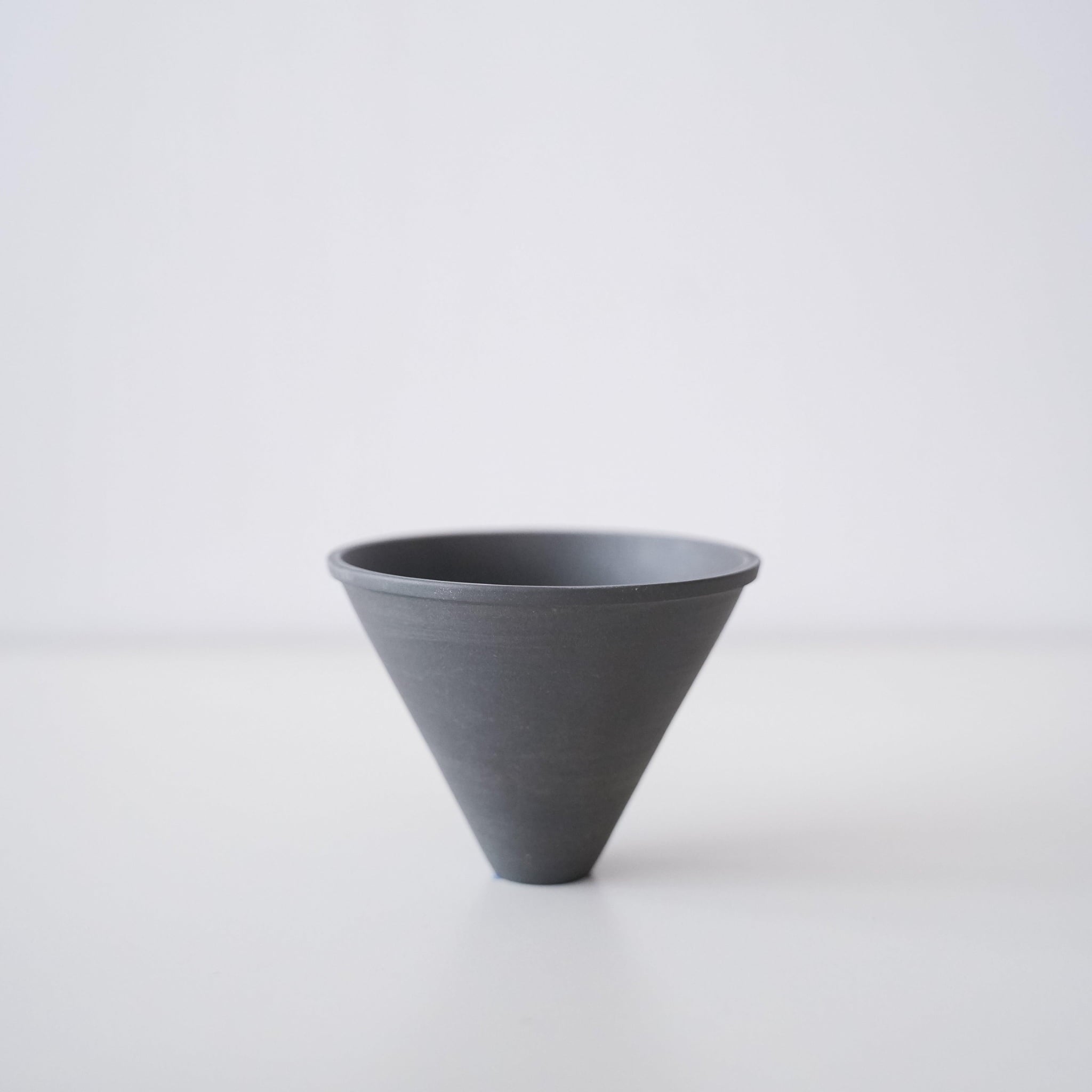 A minimalist black Banko ware coffee dripper.