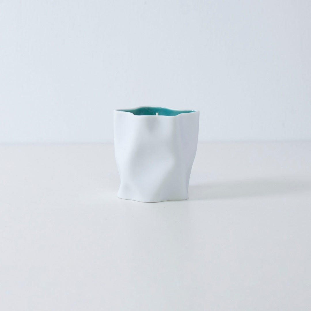 Japanese candle IKEBANA with grapefruit, camellia, and Japanese Incense in blue porcelain vessel