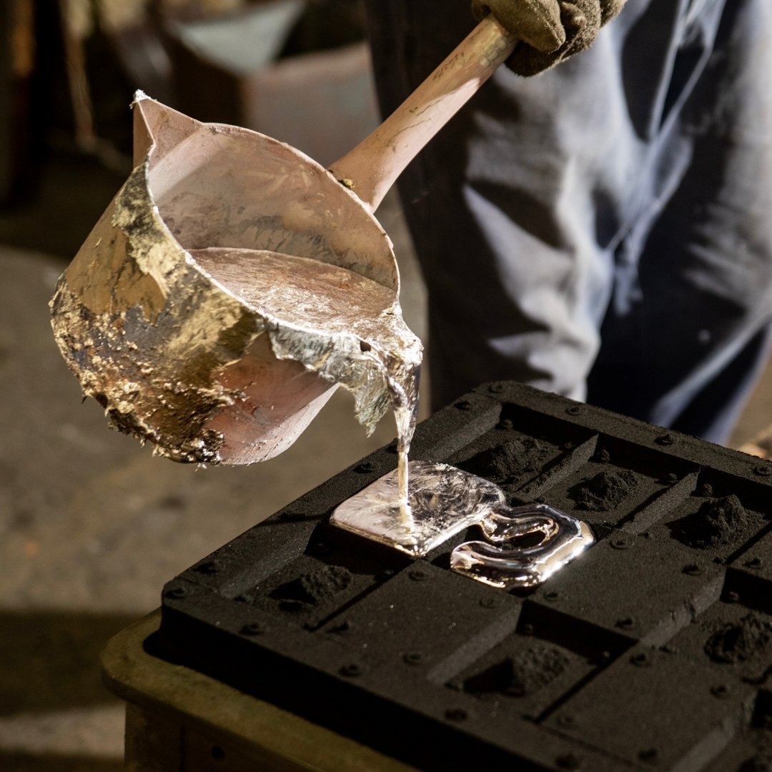 Pouring molten metal in Kanamori Alloy sand casting for ikebana kenzan and Japanese sake cup set