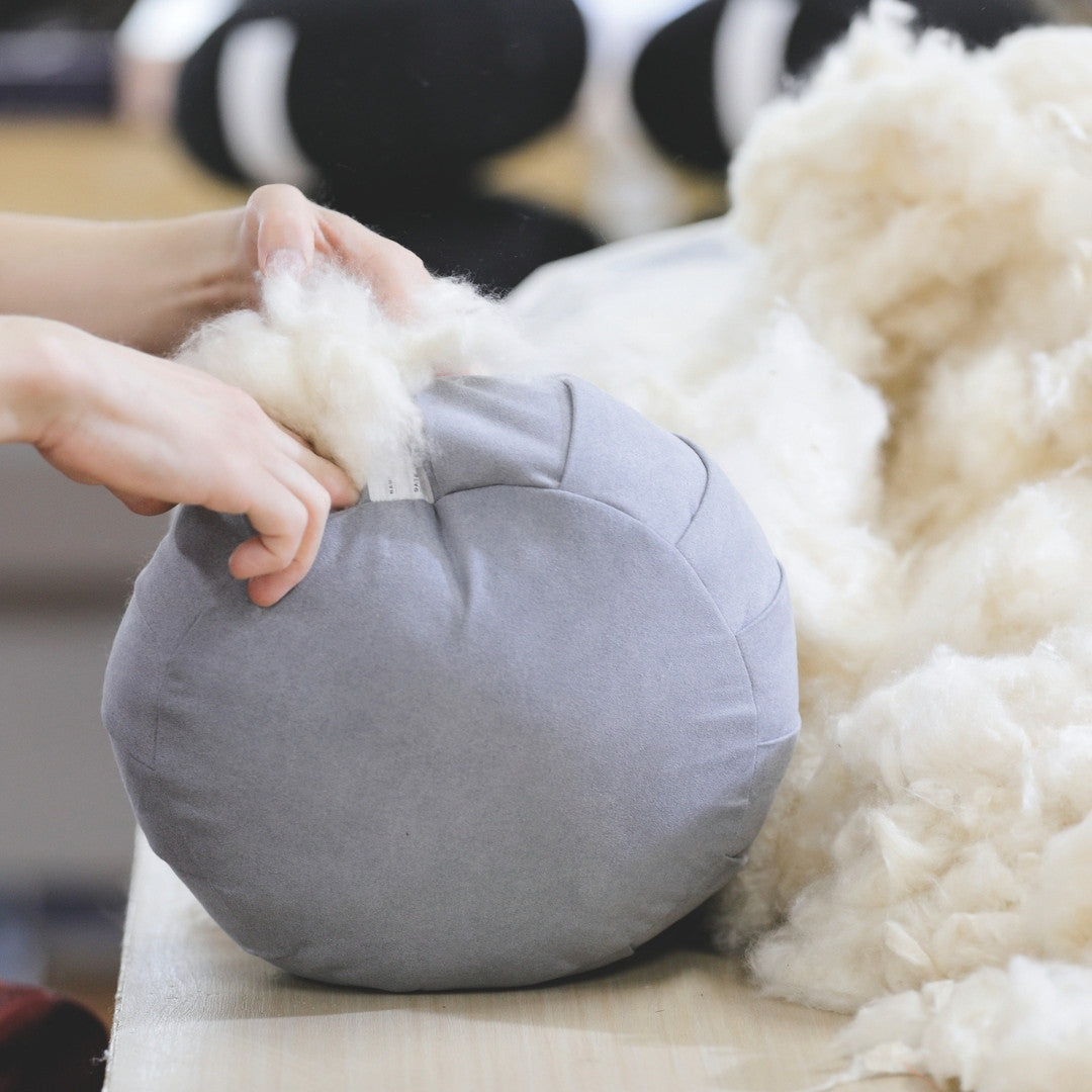 Hand-stuffing kapok fiber into Japanese meditation cushion zafu pillow ZAF MASTER